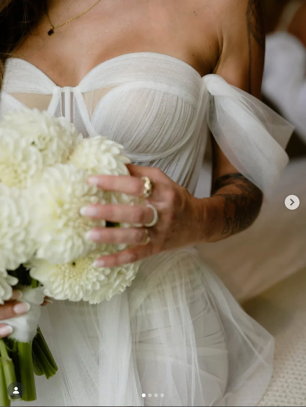 Bride holding a bouquet of white blooms by Paramithi Flowers